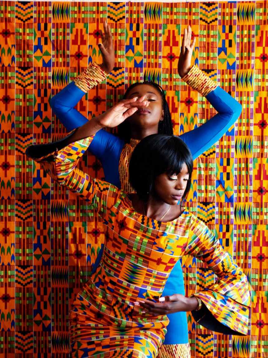 two women in dress near painted wall